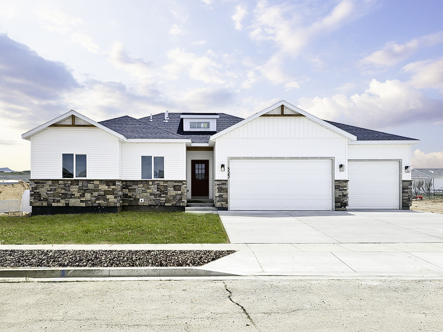 New Ranch 3-bed, 2-bath, 3-car home with unfinished basement. White siding with brown stone accents.